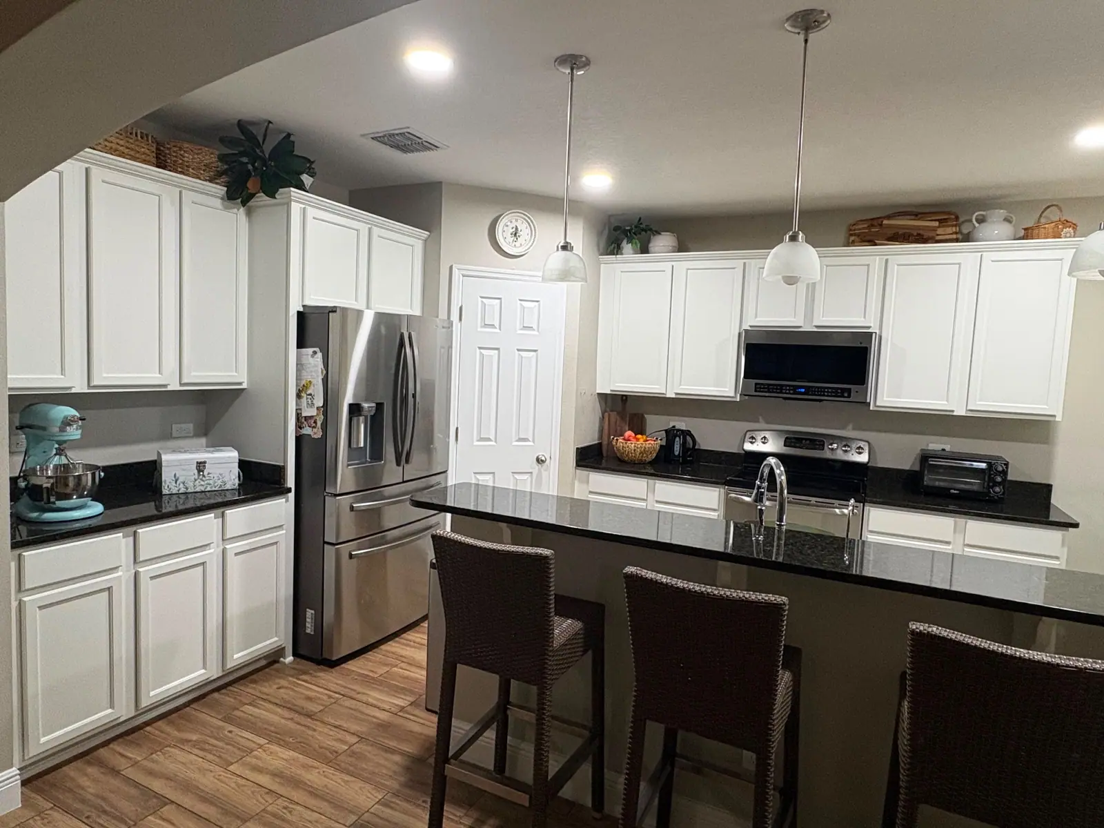 The same Ocoee kitchen with the cabinets and island painted bright white