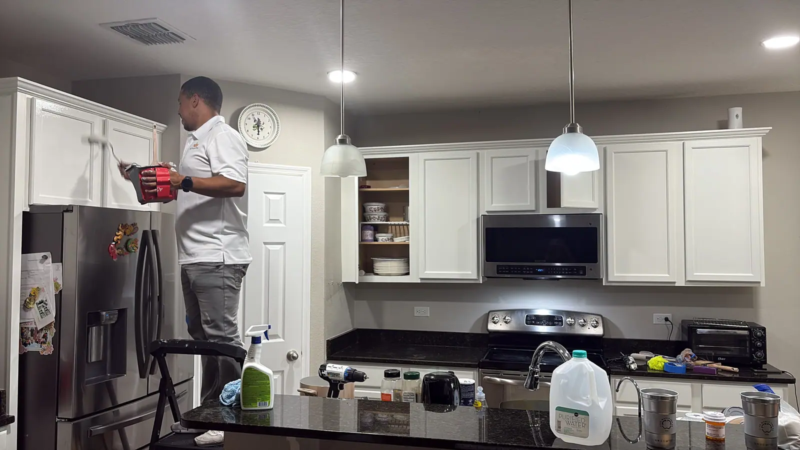 Leandro finishing the cabinet above the fridge