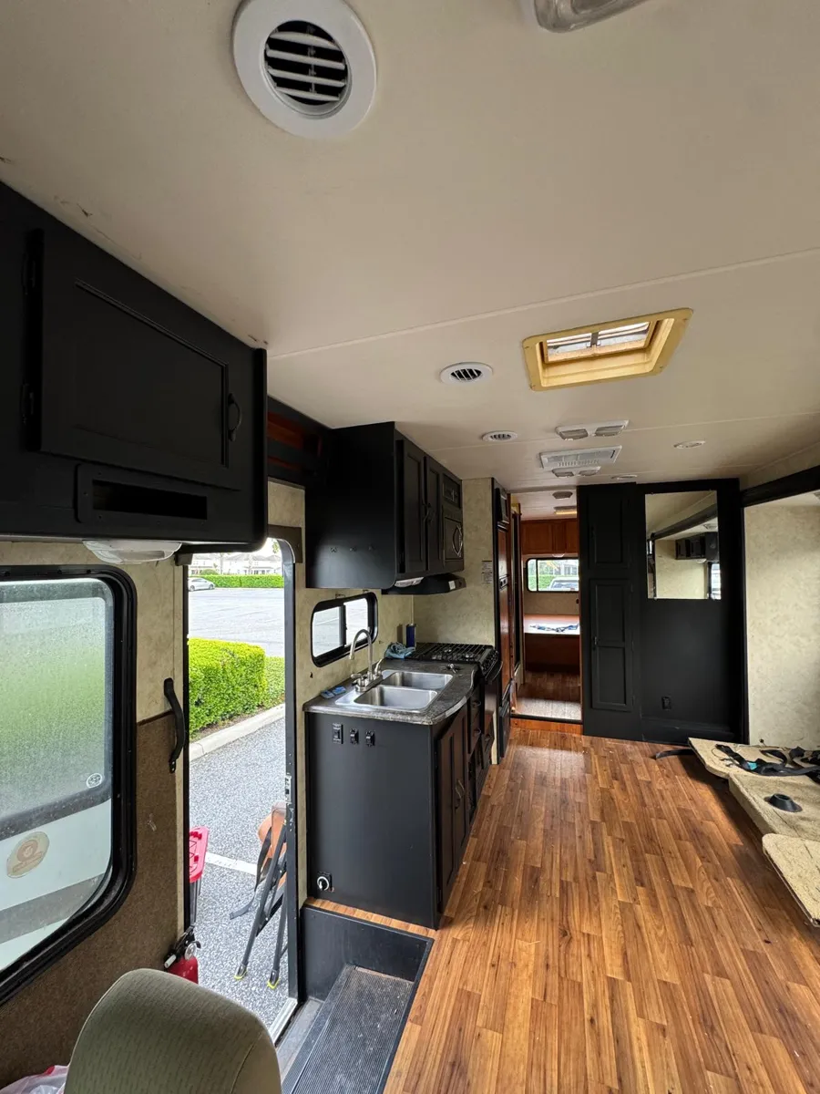 The same view down the motorhome with every cabinet painted black